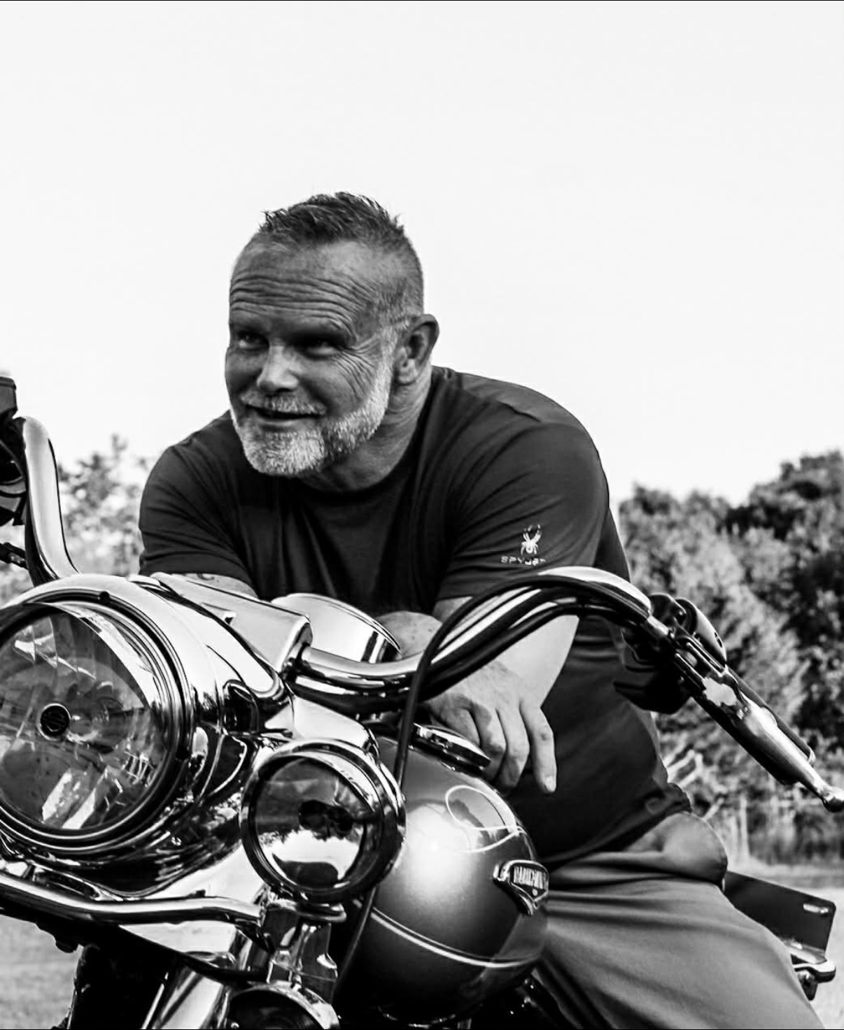 Veteran sitting next to motorcycle
